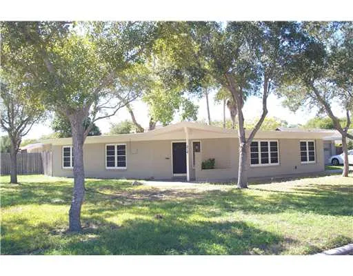 a house that has tree in front of it