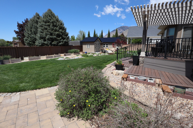 1055 North 1000 East Mapleton, UT 84664 - Photo 96 of 112 Expansive backyard featuring a manicured lawn, a privacy fence, and mature trees