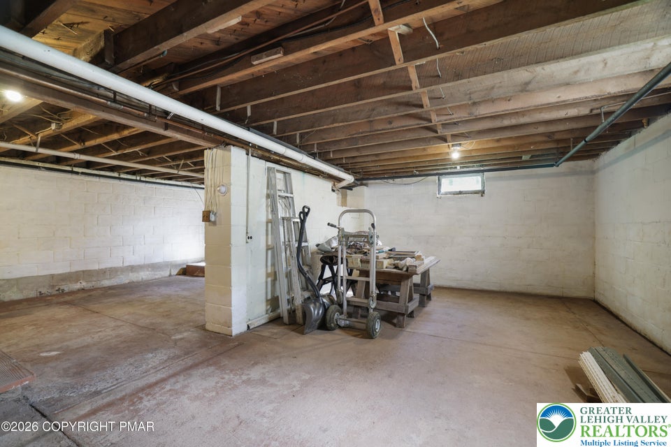 1207 Seese Hill Road Canadensis, PA 18325 - Photo 24 of 49 An unfinished lower level features durable concrete floors, block walls, and exposed wood joists.