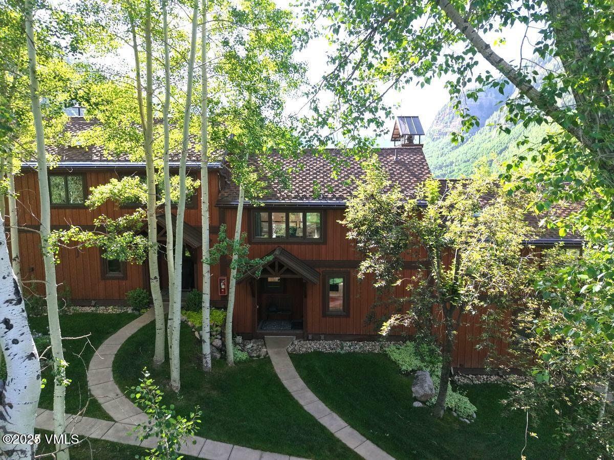 2875 Manns Ranch Road, Unit J2 Vail, CO 81657 - Photo 1 of 25 a view of a house with a tree in front of it
