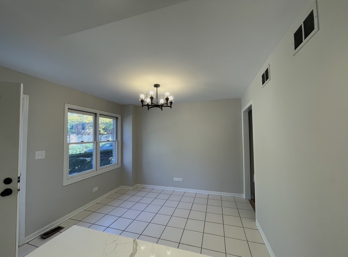 1703 Winnetka Road Northfield, IL 60093 - Photo 5 of 10 a view of an empty room with a window