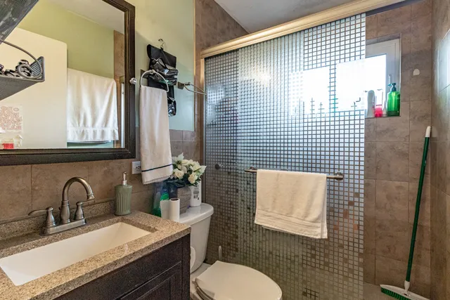 a bathroom with a sink toilet and shower