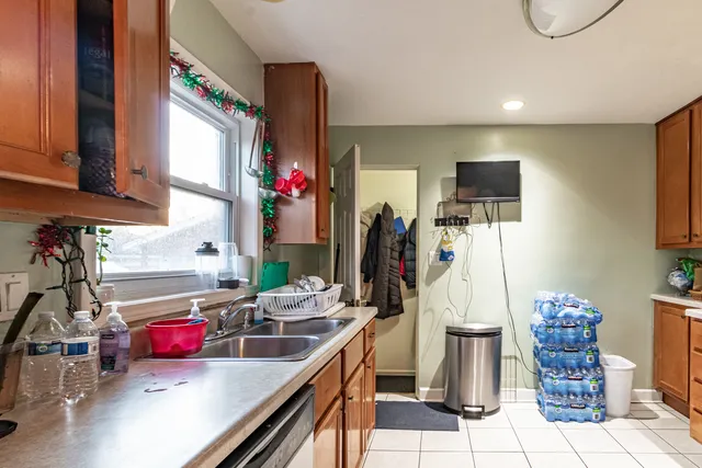 a kitchen with stainless steel appliances kitchen island granite countertop a sink and a refrigerator
