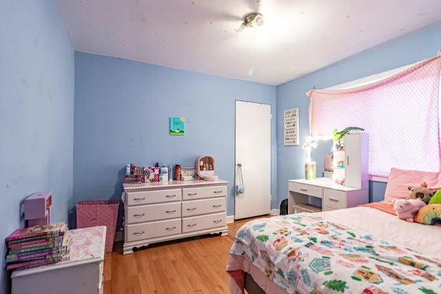 a bedroom with a bed and a dresser in it