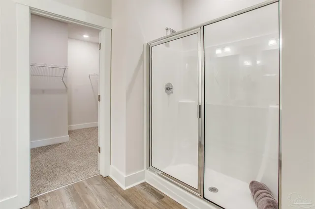 a bathroom with a glass shower door