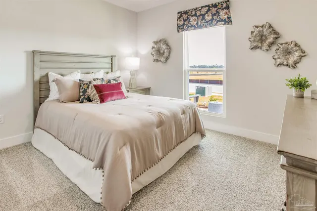 a bedroom with a bed and a mirror on dresser