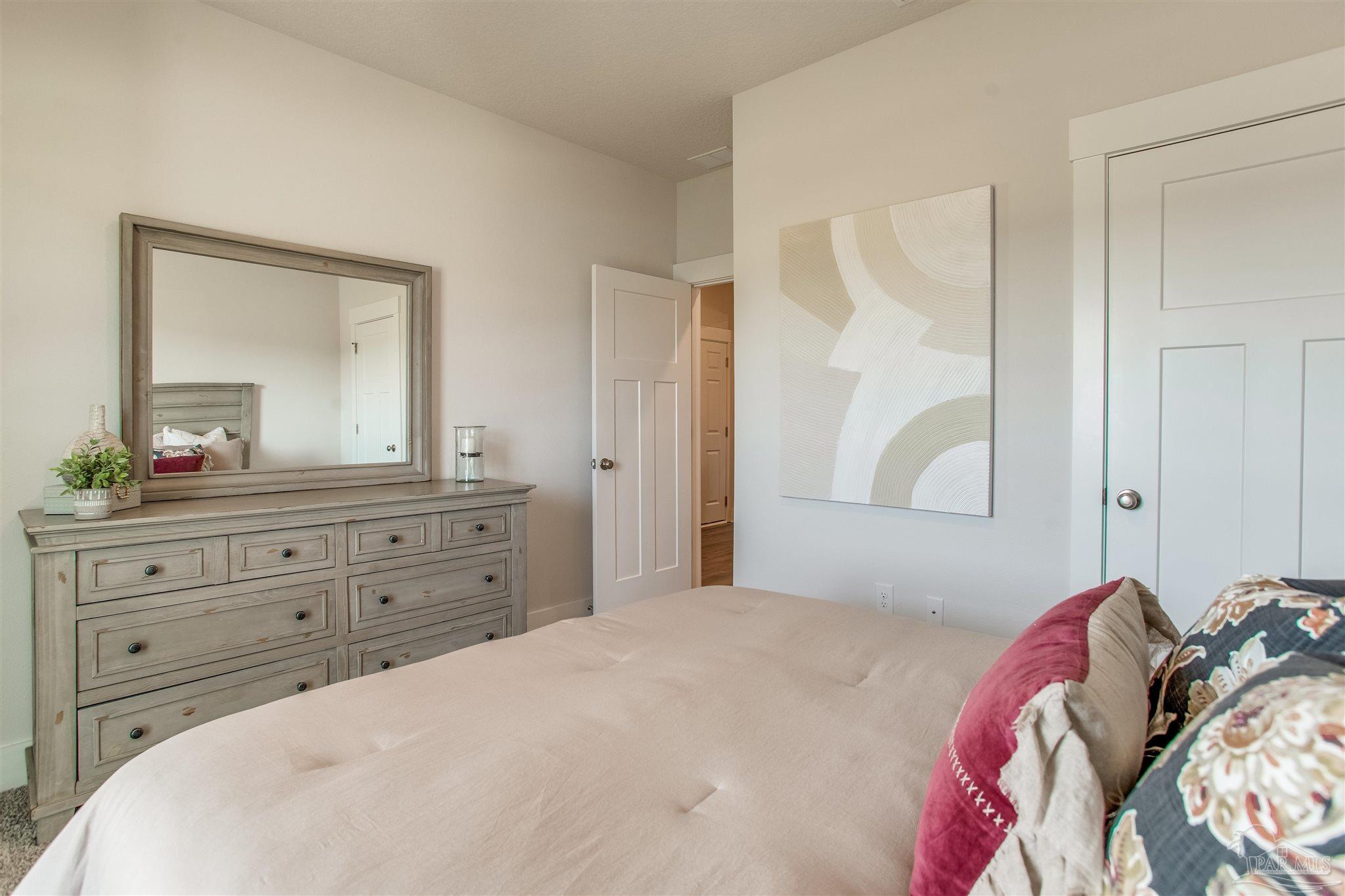 3459 Crossvine Road Cantonment, FL 32533 - Photo 30 of 38 a bedroom with a bed and a mirror on dresser