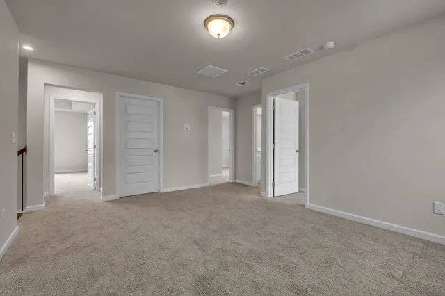 an empty room with closet and windows