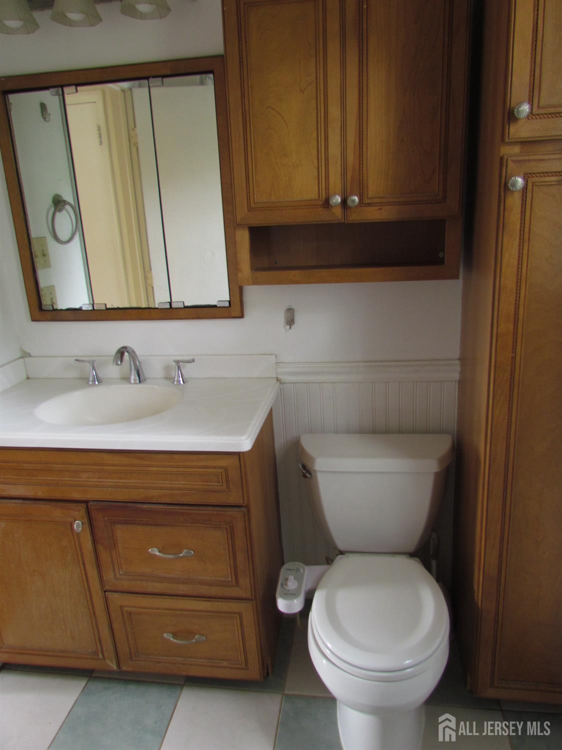10 Willow Avenue Edison, NJ 08817 - Photo 14 of 17 a bathroom with a toilet a sink and a mirror