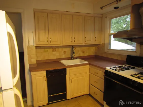 a kitchen with a stove and a cabinet