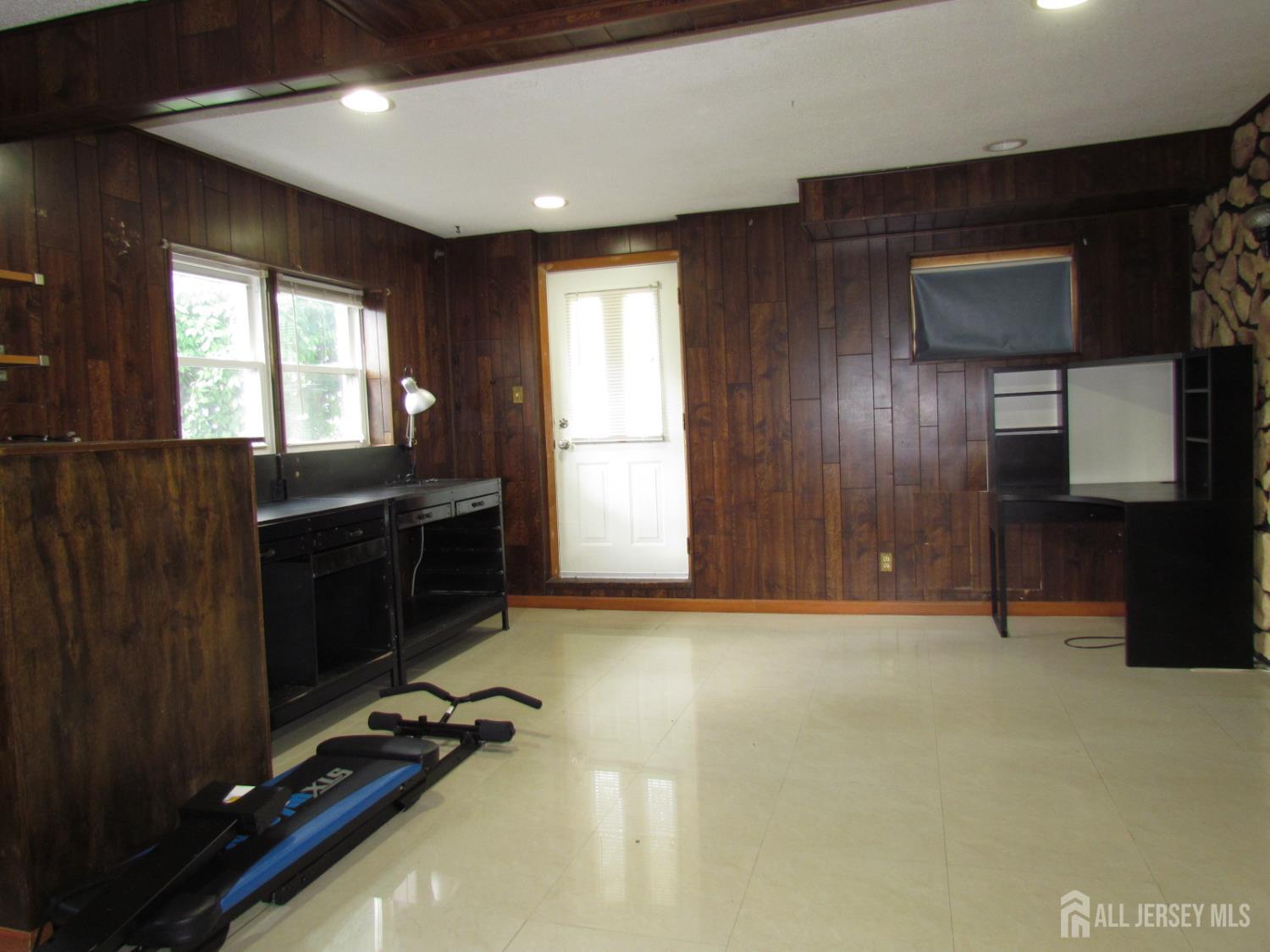 10 Willow Avenue Edison, NJ 08817 - Photo 5 of 17 a view of an empty room with a fireplace and a window