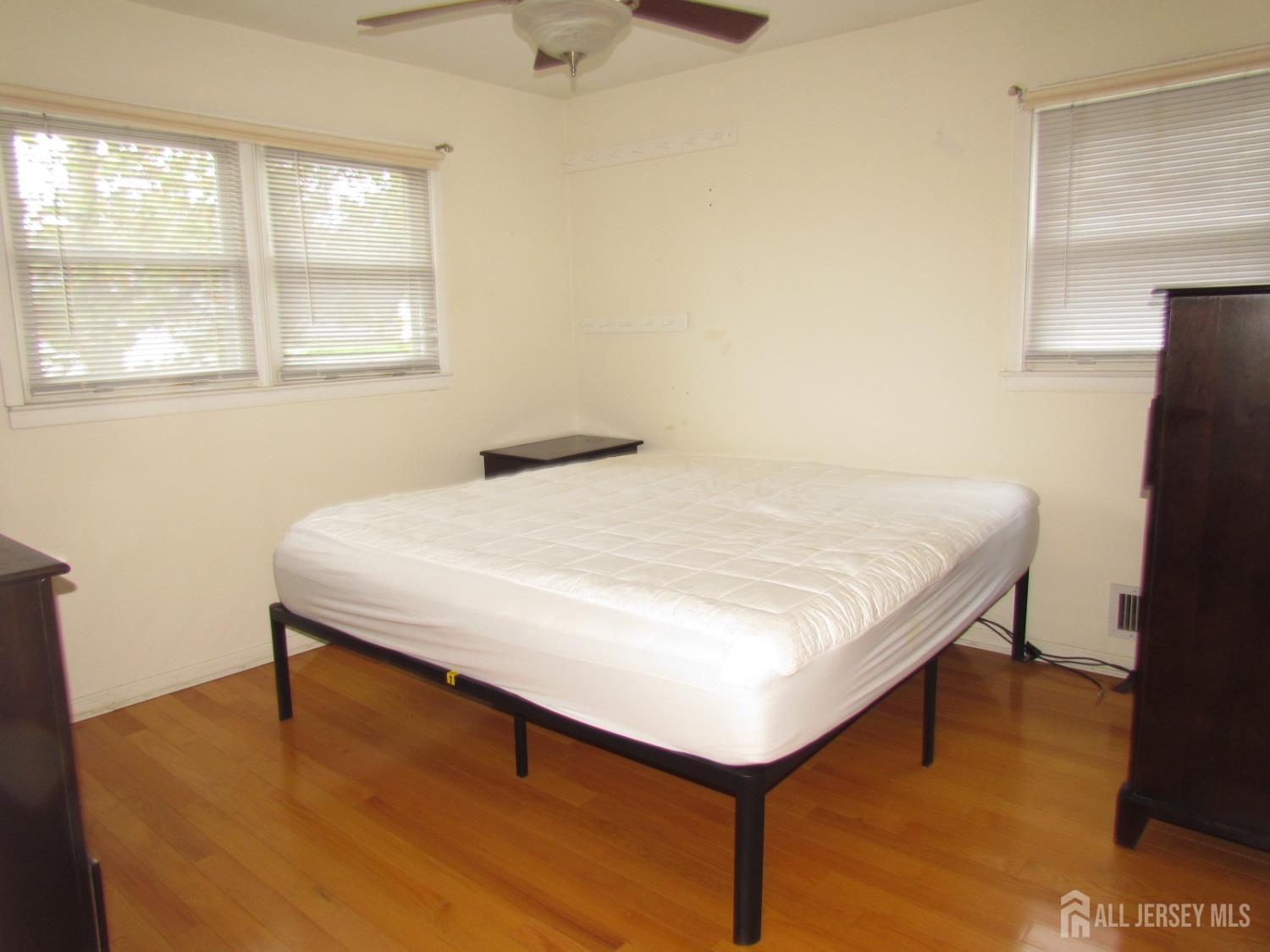 10 Willow Avenue Edison, NJ 08817 - Photo 7 of 17 a bed sitting in a bedroom next to a window