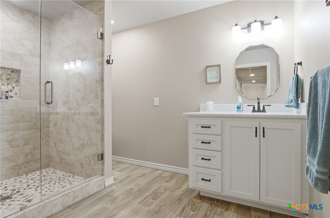 642 Phantom Rider Trail Spring Branch, TX 78070 - Photo 39 of 41 a bathroom with a sink a mirror and shower