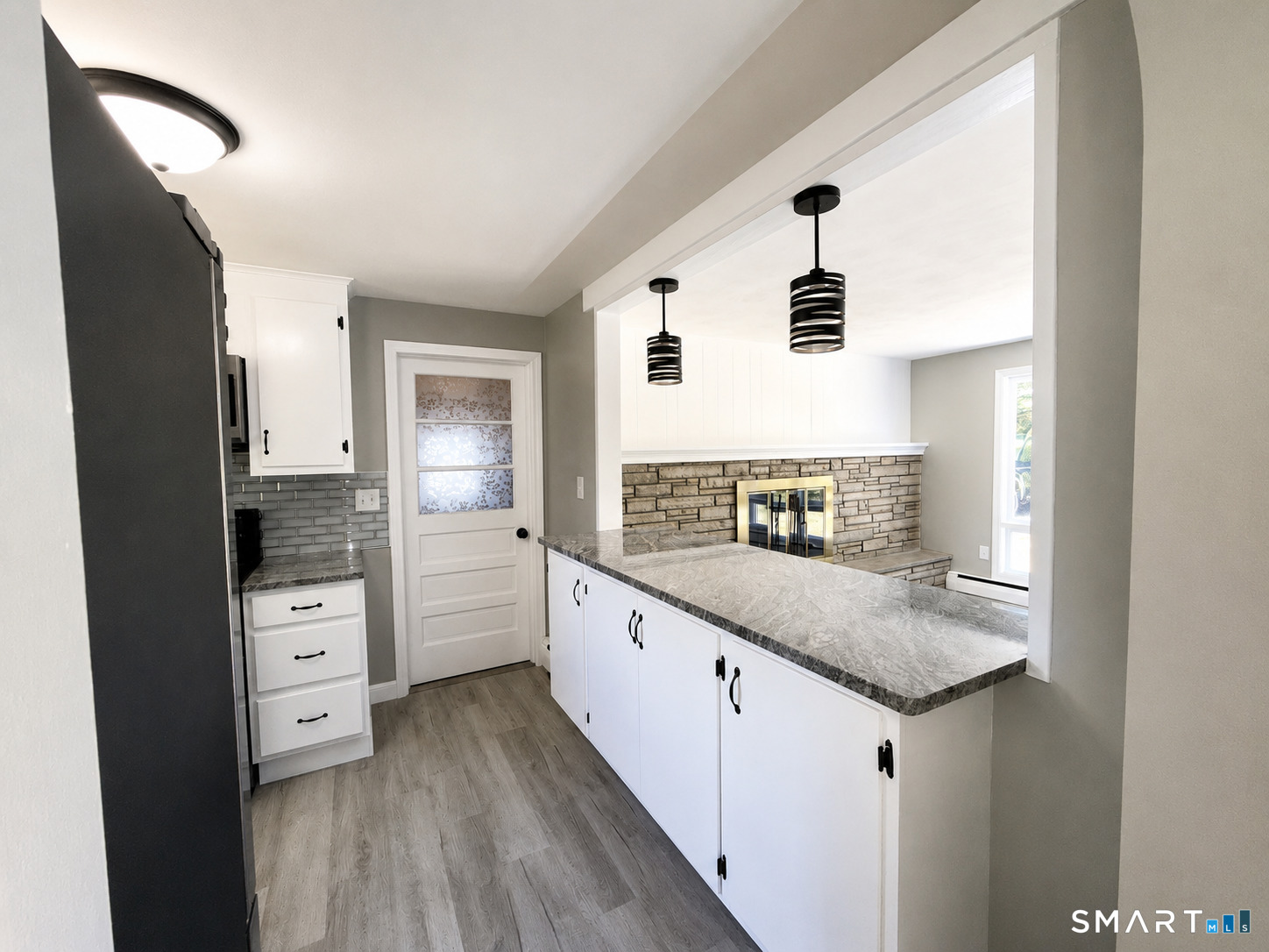 341 Harland Road Norwich, CT 06360 - Photo 5 of 29 a kitchen with stainless steel appliances granite countertop a sink and dishwasher with wooden floor