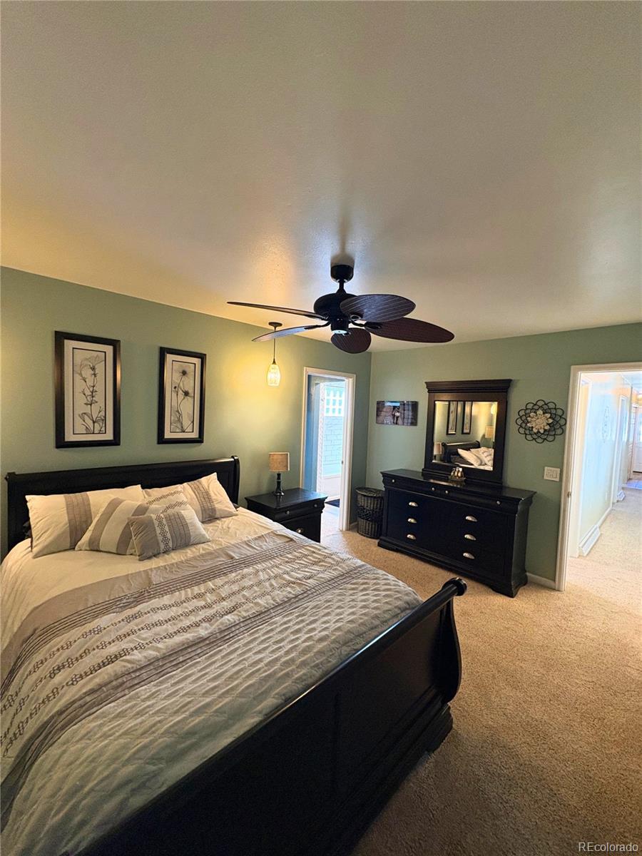 323 Fairview Street Otis, CO 80743 - Photo 15 of 38 a bedroom with a bed and a chandelier