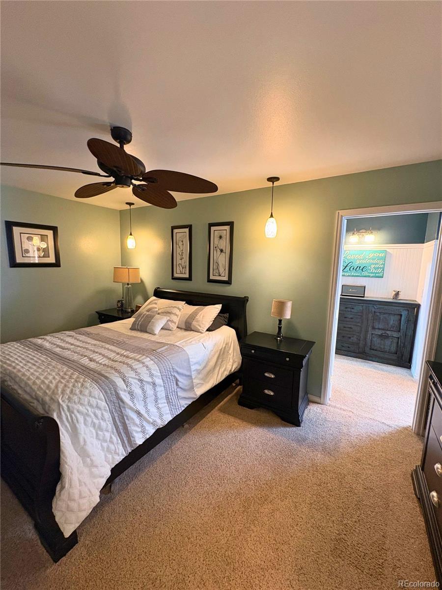 323 Fairview Street Otis, CO 80743 - Photo 16 of 38 a bed room with a bed and a lamp