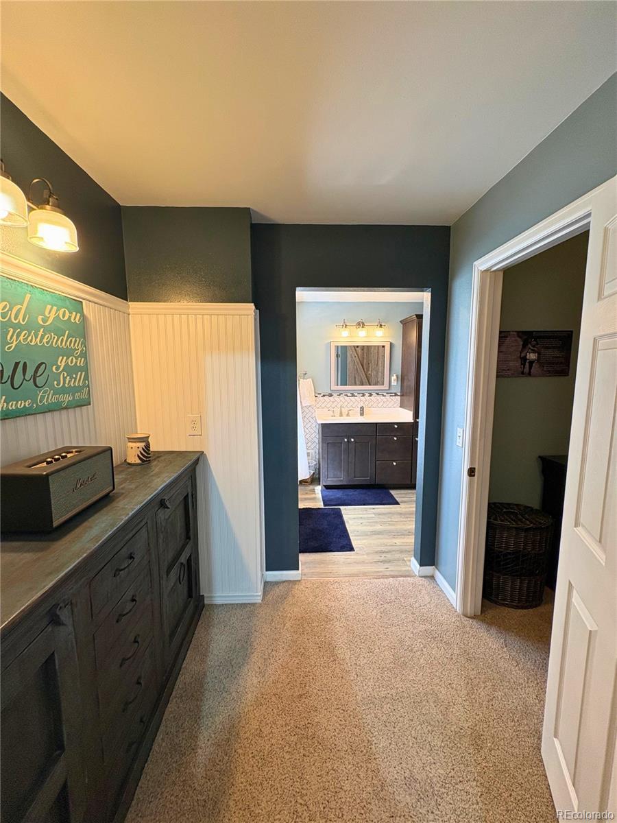 323 Fairview Street Otis, CO 80743 - Photo 20 of 38 a view of a living room with furniture and a kitchen