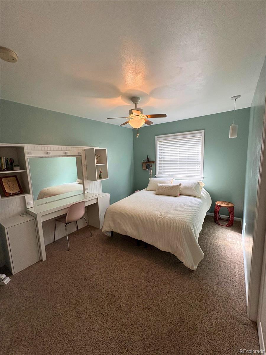 323 Fairview Street Otis, CO 80743 - Photo 23 of 38 a bedroom with a bed and a chair