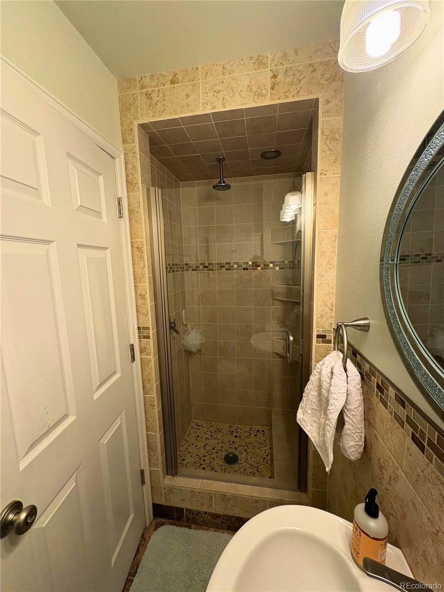 323 Fairview Street Otis, CO 80743 - Photo 25 of 38 a bathroom with a sink mirror vanity and toilet