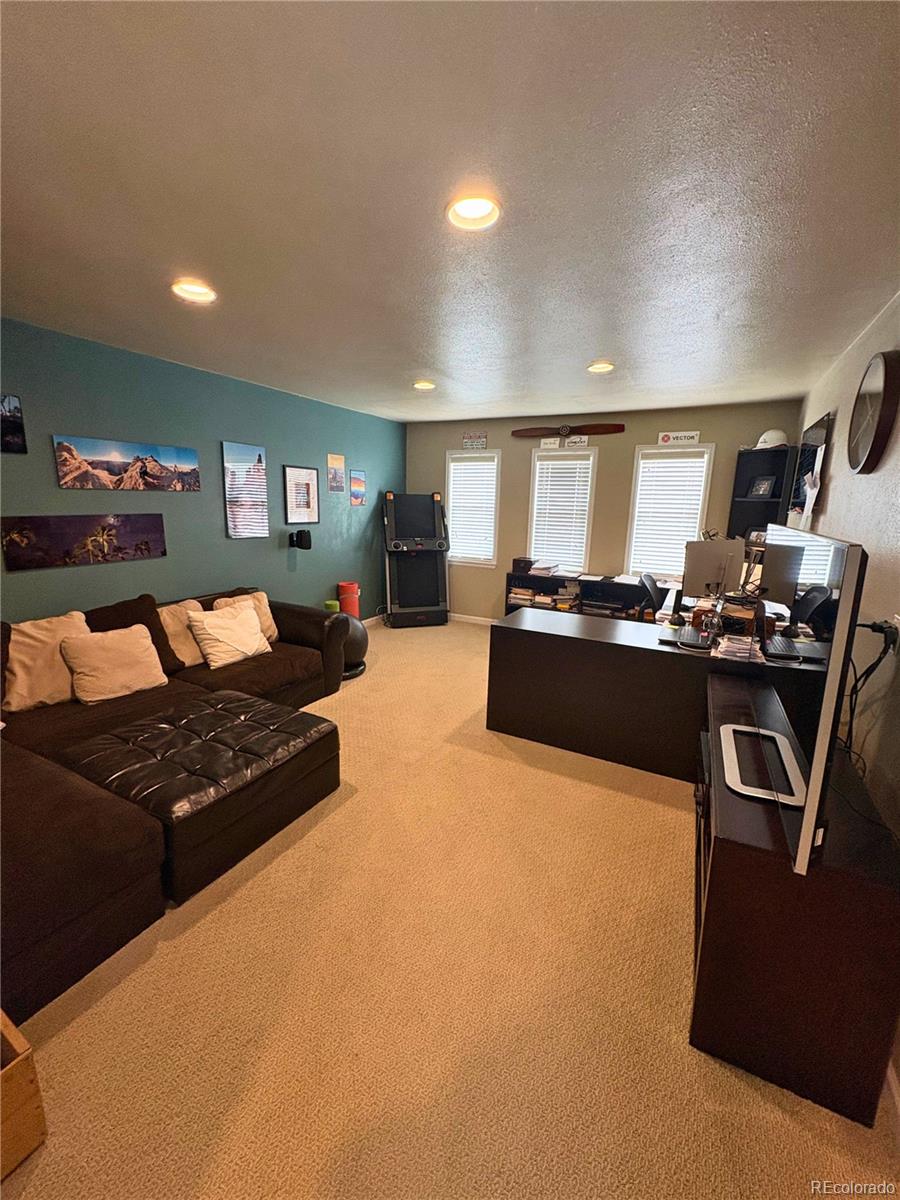 323 Fairview Street Otis, CO 80743 - Photo 26 of 38 a kitchen with stainless steel appliances granite countertop a stove and a refrigerator