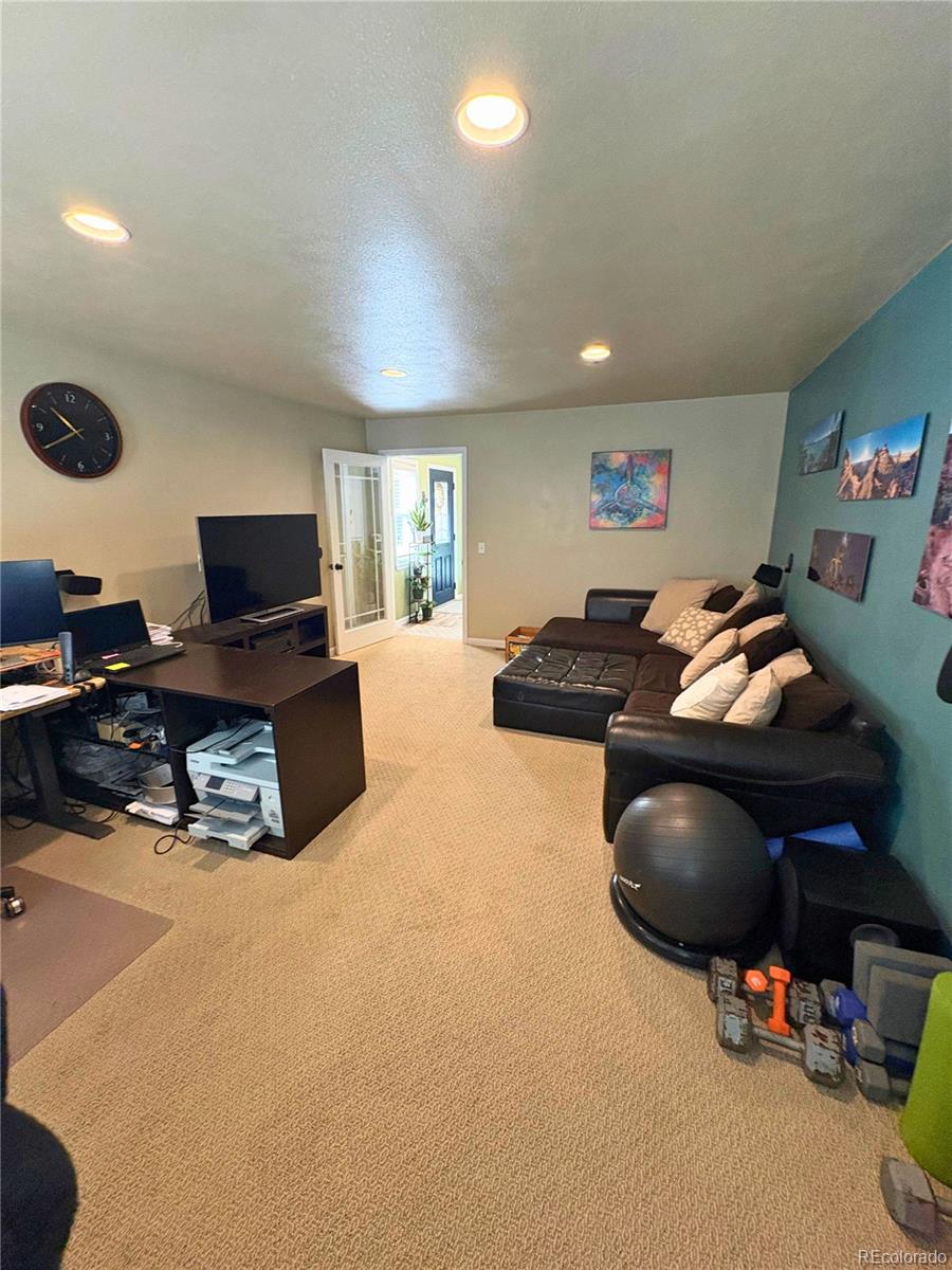 323 Fairview Street Otis, CO 80743 - Photo 27 of 38 a living room with furniture and a flat screen tv