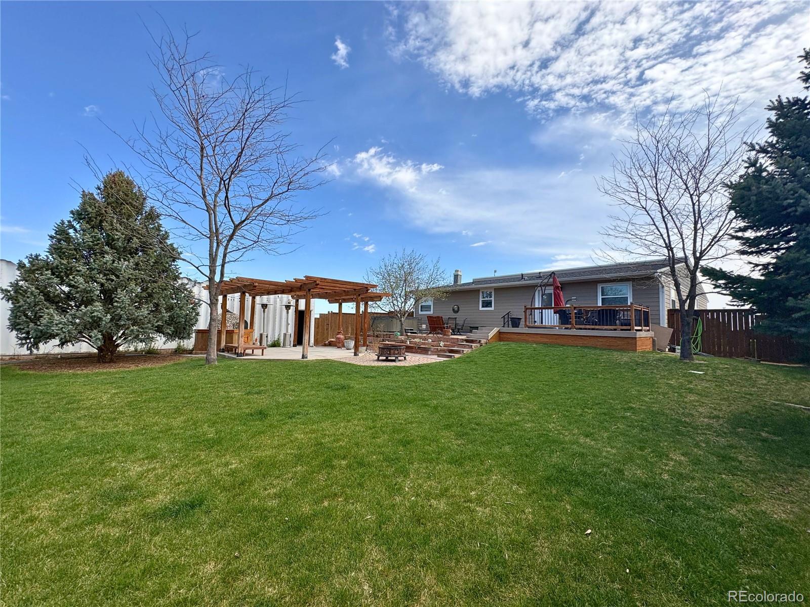 323 Fairview Street Otis, CO 80743 - Photo 35 of 38 a view of a house with a big yard and large trees