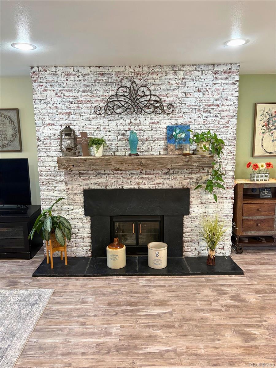 323 Fairview Street Otis, CO 80743 - Photo 9 of 38 a living room with furniture and a fireplace