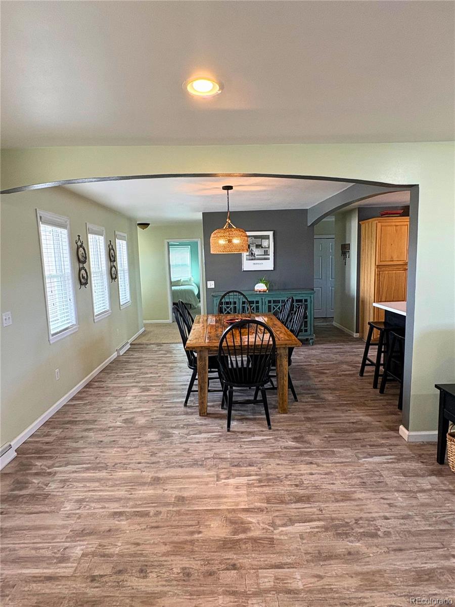 323 Fairview Street Otis, CO 80743 - Photo 10 of 38 a bedroom with furniture and a wooden floor