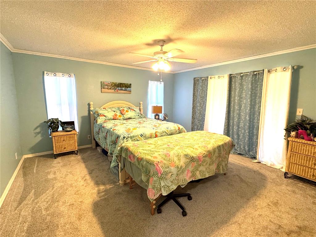7425 South Irma Point Lecanto, FL 34461 - Photo 20 of 61 a bedroom with a bed and a chandelier
