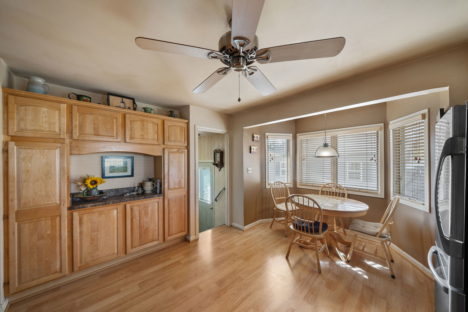 1500 Harding Avenue Berkeley, IL 60163 - Photo 12 of 22 a view of a livingroom with furniture hardwood floor and a ceiling fan