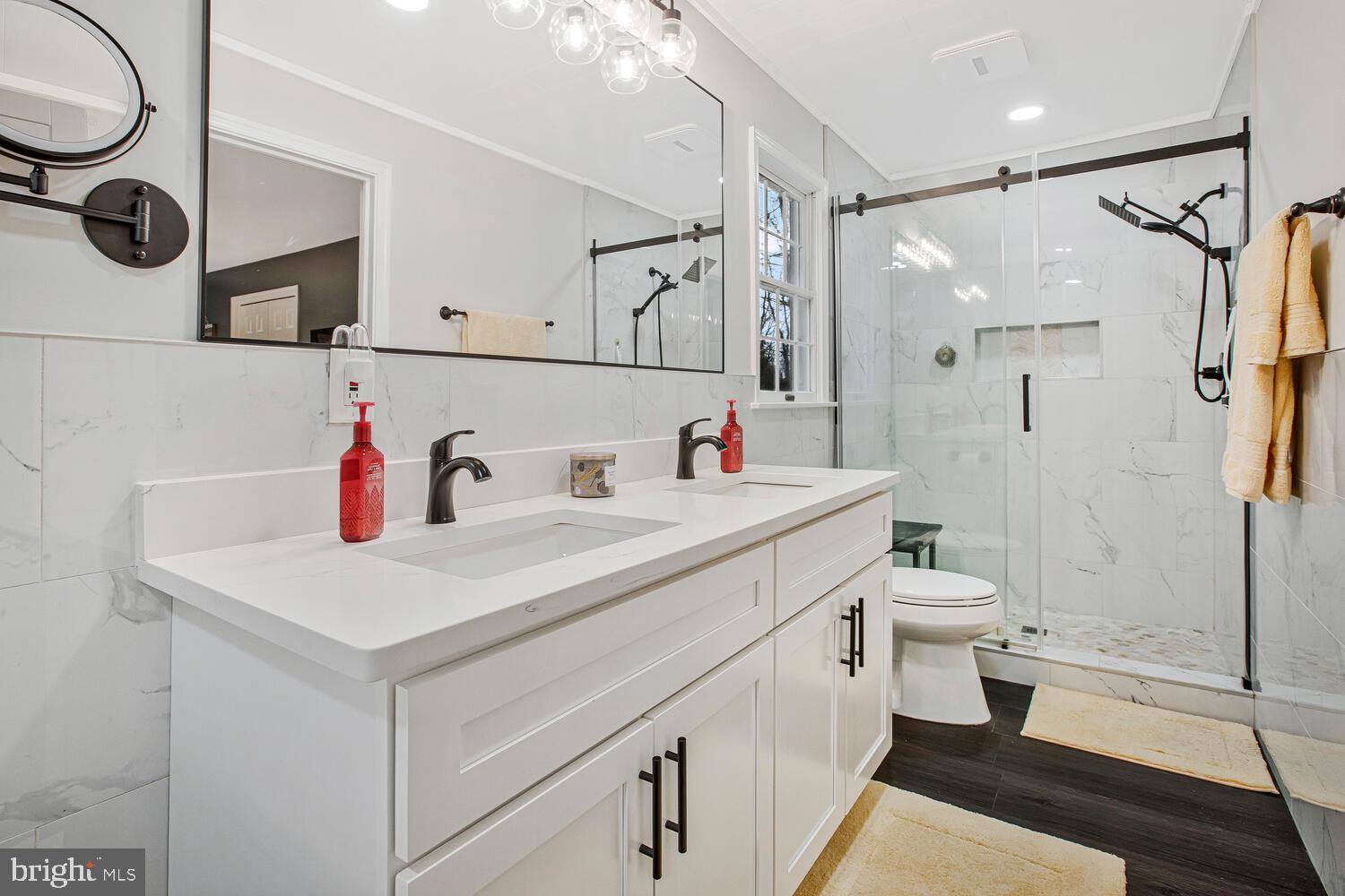 1505 Pinnacle Road Towson, MD 21286 - Photo 17 of 34 a bathroom with a sink vanity mirror and toilet