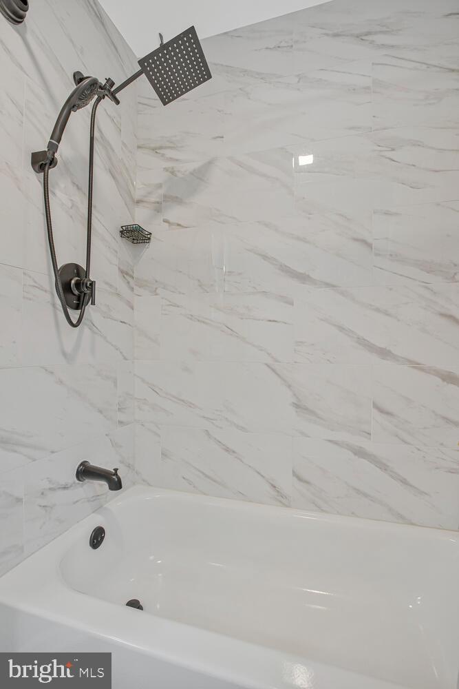 1505 Pinnacle Road Towson, MD 21286 - Photo 23 of 34 a bathroom with a shower and a bath tub