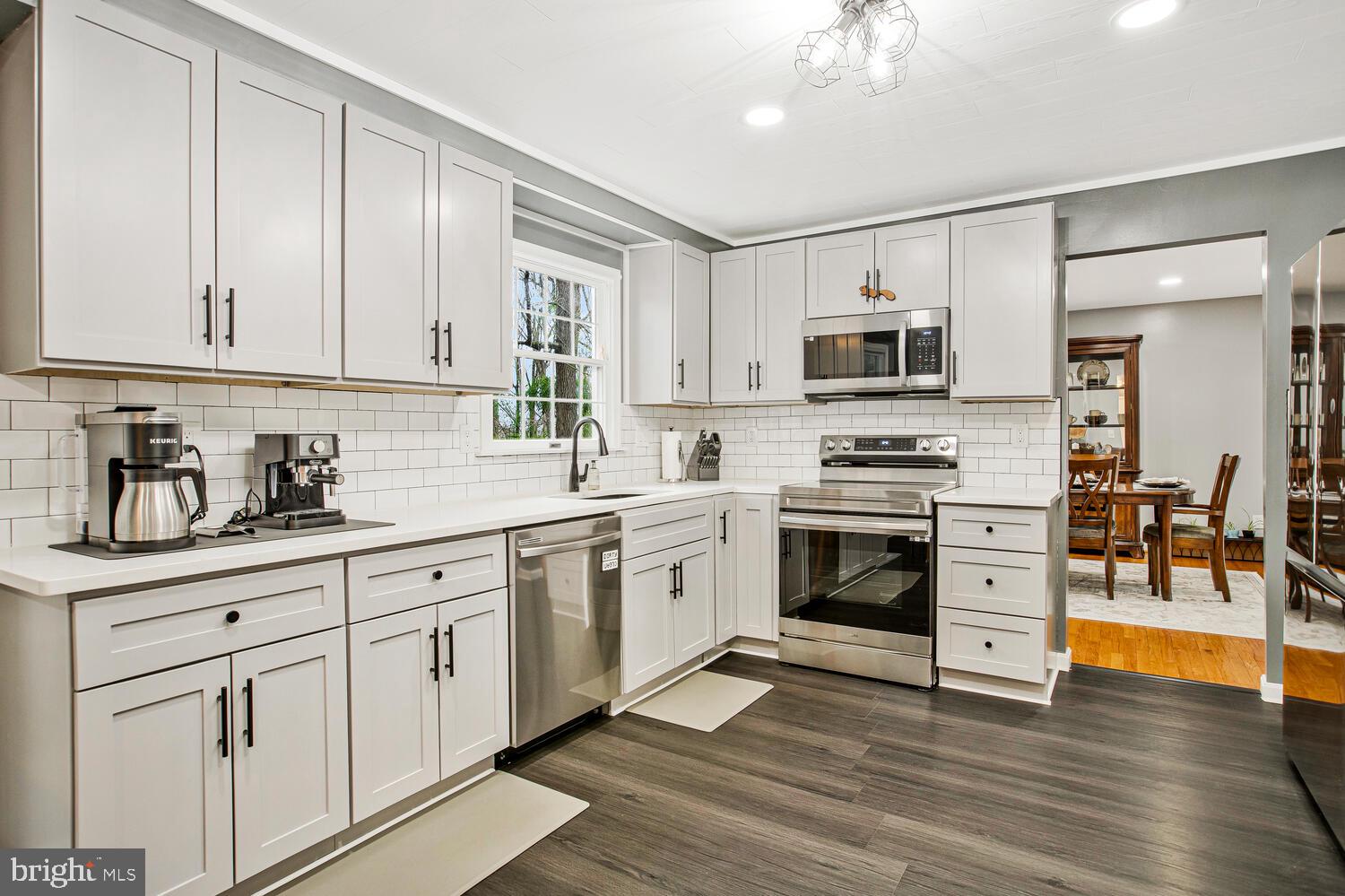 1505 Pinnacle Road Towson, MD 21286 - Photo 9 of 34 a kitchen with granite countertop white cabinets and stainless steel appliances