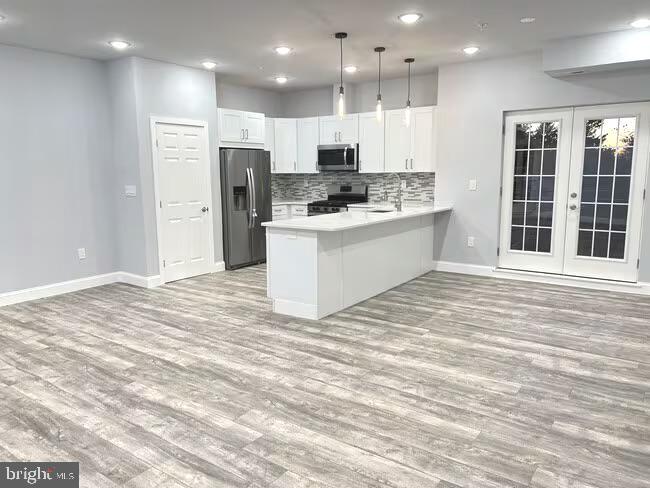 1237 Lancaster Avenue, Unit 1 Berwyn, PA 19312 - Photo 2 of 17 a large white kitchen with kitchen island white cabinets and stainless steel appliances