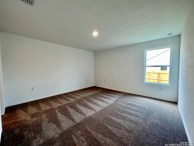 a view of an empty room and a window