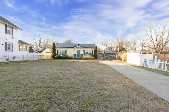 a view of large building with cars parked in front of it