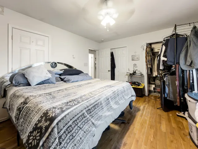 a bedroom with a bed and a mirror