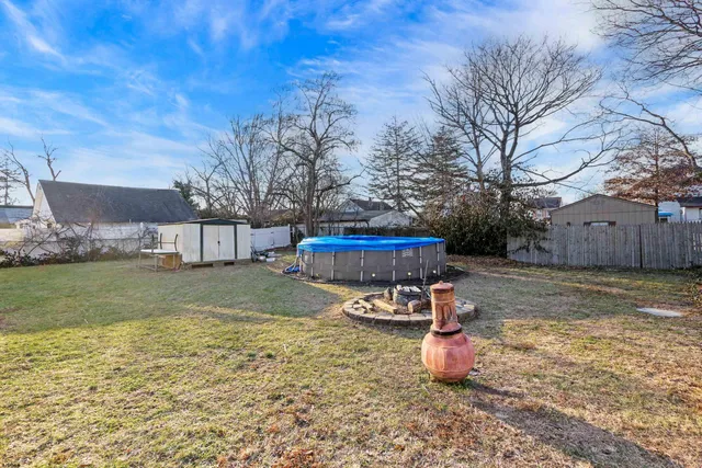 a view of a backyard with table and chairs