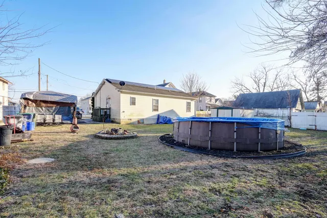 a view of a house with backyard and sitting area