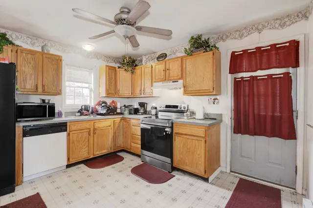 a kitchen with granite countertop a sink stainless steel appliances and cabinets