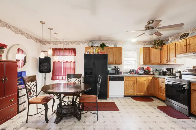 a kitchen with stainless steel appliances granite countertop a refrigerator and microwave