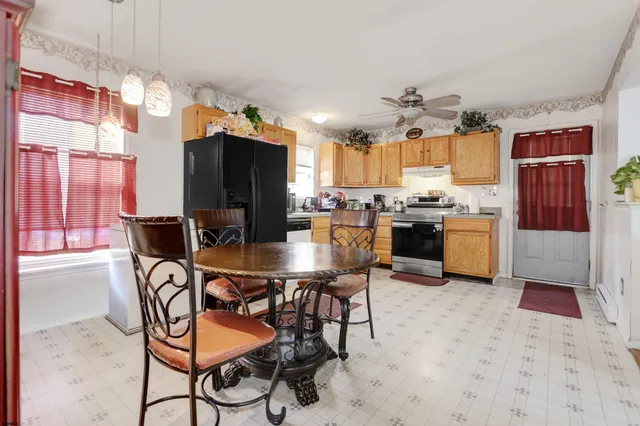 a view of a dining room with furniture and a chandelier