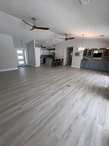 a view of a room with wooden floor