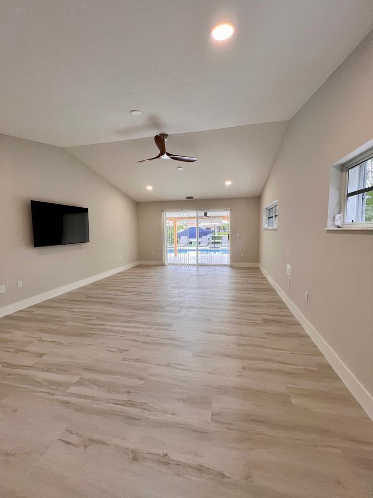 641 12th Street Key Colony Beach, FL 33051 - Photo 18 of 45 a view of an empty room with wooden floor and a window