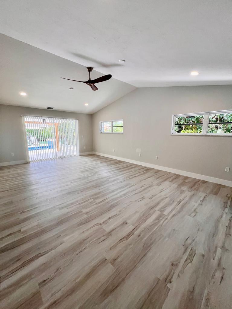 641 12th Street Key Colony Beach, FL 33051 - Photo 19 of 45 an empty room with wooden floor and ceiling fan