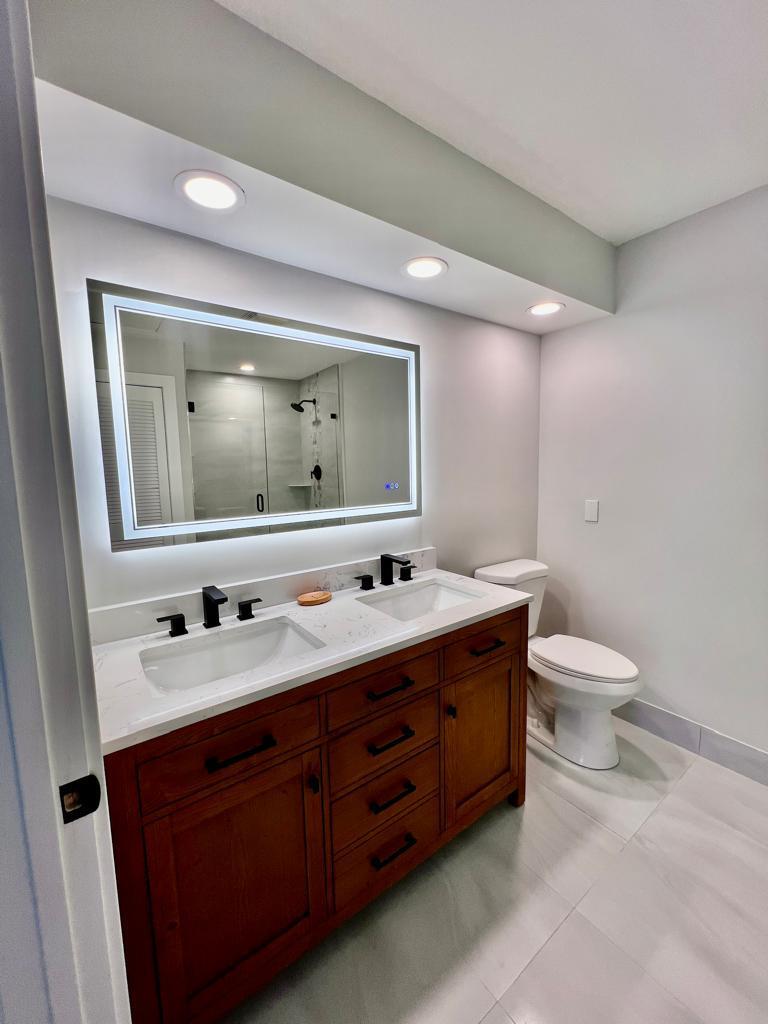 641 12th Street Key Colony Beach, FL 33051 - Photo 21 of 45 a bathroom with a double vanity sink and mirror with toilet