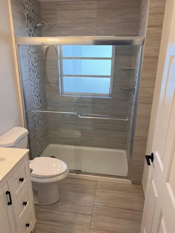a bathroom with a toilet and a shower