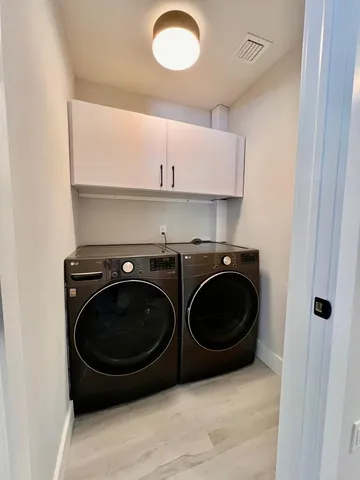 a utility room with sink dryer and washer