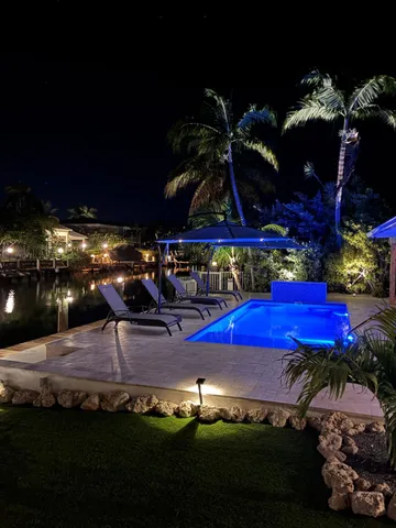 a view of a swimming pool with an outdoor seating
