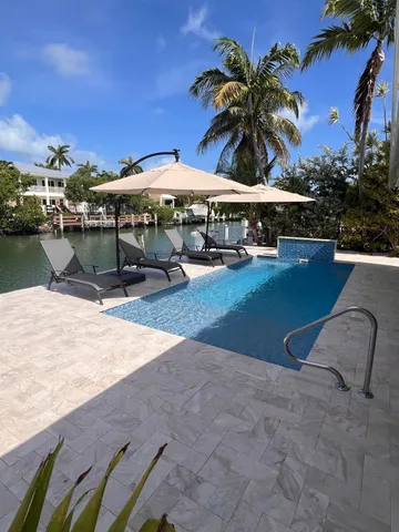 swimming pool view with a seating space
